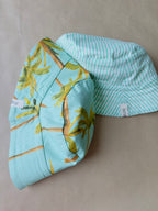 Unisex reversible  hat with palm trees and green sky
Stay cool and stylish with our Cotton Reversible Bucket Hat – two stylish looks in one comfy, breathable, light-weight hat. Crafted from 100% cotton, it’s perfect for sunny days, travel, or casual outings.

2 in 1 style - Flip it to match your mood or outfit!