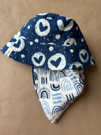 Unisex reversible  hat with blue heart print and aesthetics
Stay cool and stylish with our Cotton Reversible Bucket Hat – two stylish looks in one comfy, breathable, light-weight hat. Crafted from 100% cotton, it’s perfect for sunny days, travel, or casual outings.

2 in 1 style - Flip it to match your mood or outfit!