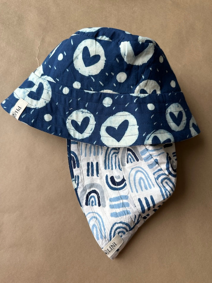Unisex reversible  hat with blue heart print and aesthetics
Stay cool and stylish with our Cotton Reversible Bucket Hat – two stylish looks in one comfy, breathable, light-weight hat. Crafted from 100% cotton, it’s perfect for sunny days, travel, or casual outings.

2 in 1 style - Flip it to match your mood or outfit!